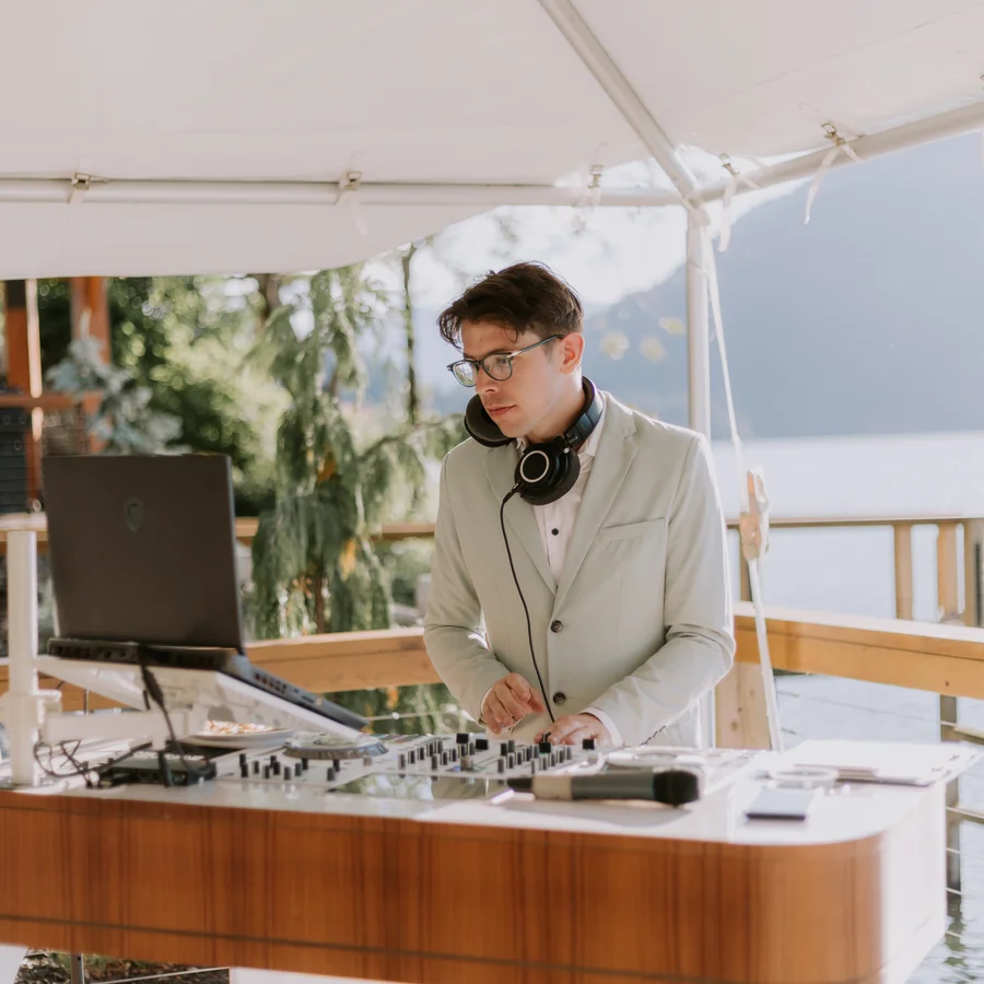A Pardy DJ working quietly behind the booth at a lakeside Fraser Valley wedding reception.